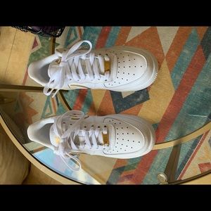 White Nike Air Force with gold outline.